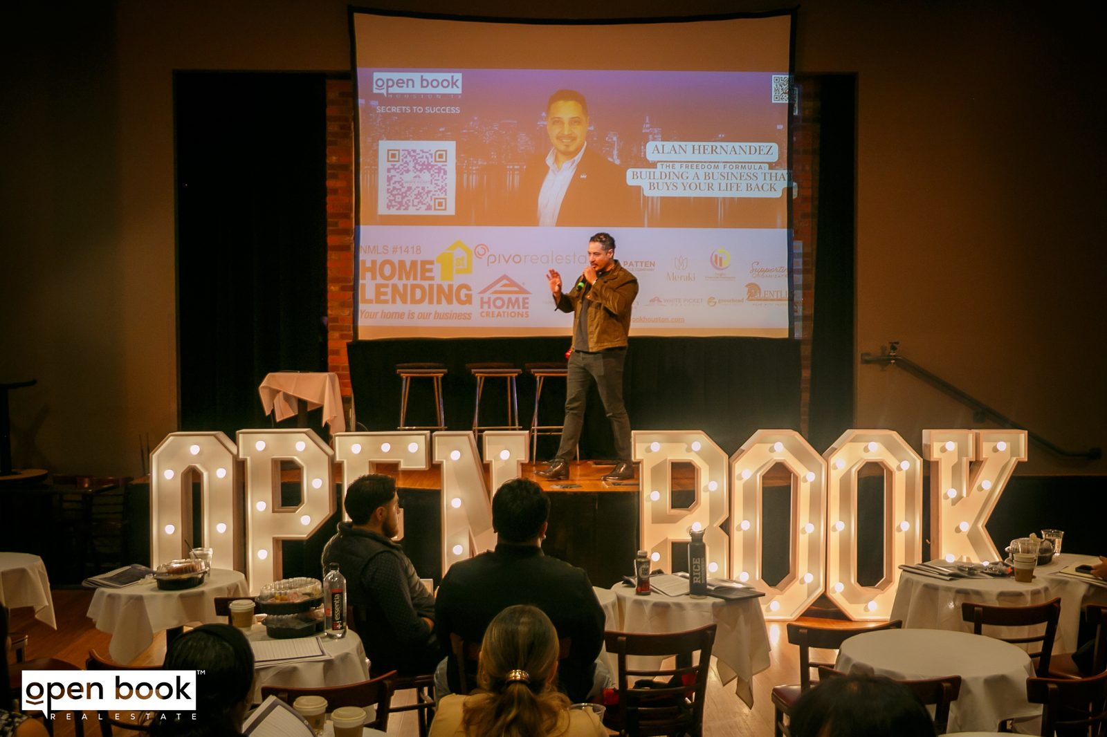 Alan R. Hernandez speaking on stage